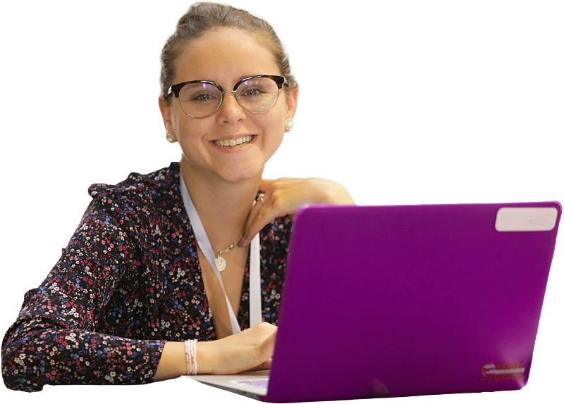 A woman wearing glasses and working at a bright purple laptop.